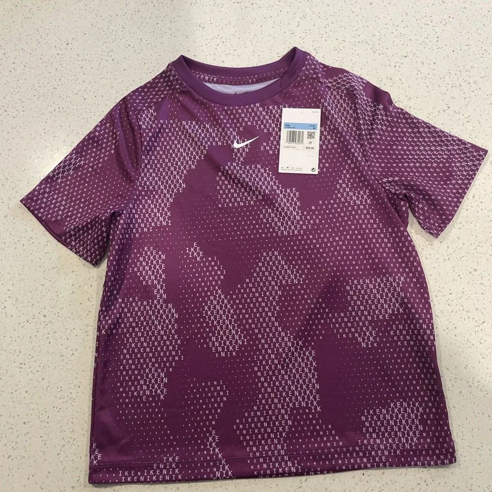NWT Nike dri fit T, Kids M purple, Nike print in writing throughout, $35